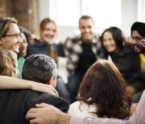 group of people talking in circle